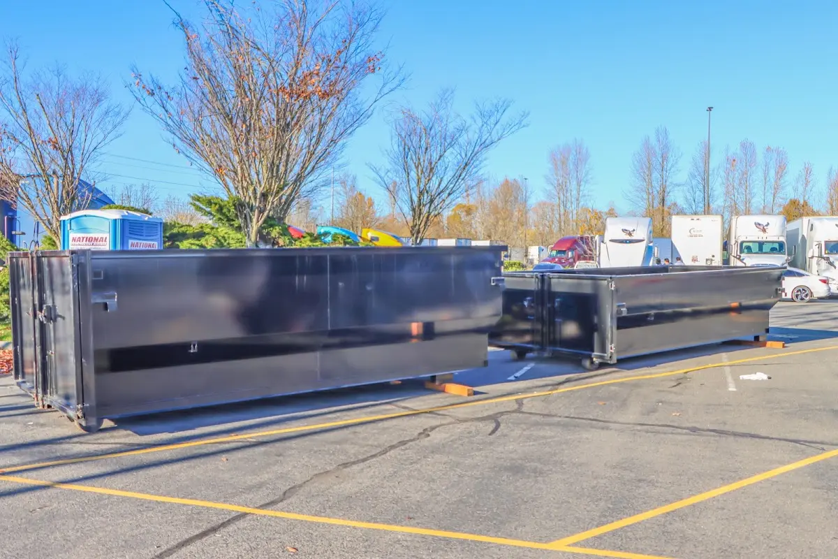 Professional dumpster rental service with roll-off container on residential driveway in Eudora